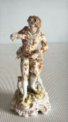 Porcelain figure of a flower-strewing gallant in floral suit, standing on a rococo scroll base,