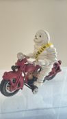 Cast iron Michelin man on motorbike