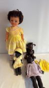 Group of four vintage plastic dolls with clothing