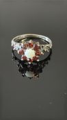 8ct White gold ring set with opal & garnets Weight