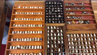 Collection of decorative thimbles with wooden display cases