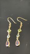 Pair of Yellow metal earrings set with garnets 1.