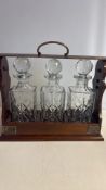 Tantalus with three cut crystal decanters