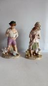 Pair of Continental porcelain figurines of farm children (hairline to one)
