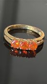 9ct Gold ring set with 3 orange stones Weight 2.4g