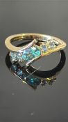 18K yellow gold ring claw-set with one oval-cut Russian alexandrite and four round alexandrites,