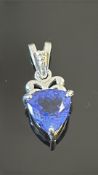 18k white gold pendant centring a trilliant-cut AAAA Tanzanite, approximately 3.39 ct, claw-set