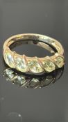 9ct Gold ring set with 5 peridot stones Weight 2.2