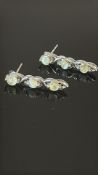 Pair of 9ct white gold earring set with cabochon g