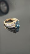 9ct Gold ring set with blue topaz & diamond Weight