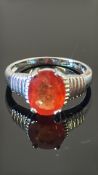 18K white gold ring claw-set with an oval 10 × 8 mm Madagascan padparadscha sapphire, stated