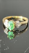 18k yellow gold ring centring an oval Kenyan tsavorite garnet, approx 0.76 ct, flanked by four round