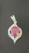 18K white gold pendant centring an oval mixed-cut Madagascar ruby of approx. 2.18 ct, framed by