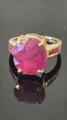 18K yellow-gold ring featuring an oval 13.5 × 12 mm Madagascar “Royal” ruby of c.10.44 ct, flanked