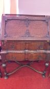 Early 20th-century carved oak bureau on stand