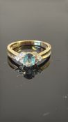 18K yellow gold ring centring an oval Russian alexandrite (approx. 0.70 ct, 6.5 × 5 mm) flanked by