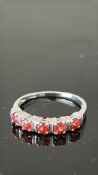 9ct Gold ring set with red garnets Weight 1.9g