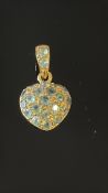 9ct Gold heart pendant set with green stones Weig