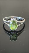 18K white gold ring claw-set with an oval Mozambique Paraiba tourmaline of approximately 1.04 ct,