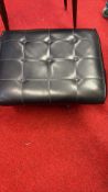 Button-tufted black vinyl storage footstool