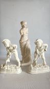 Group of three cream-glazed ceramic figurines