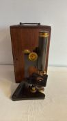 Early 20th-century brass and black metal microscope with case