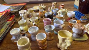 Collection of mid-20th century novelty ceramic egg cups and toast racks