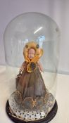 Wax doll under glass dome