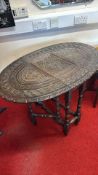 Carved oak oval occasional drop-leaf table