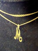 9ct gold 'M' pendant suspended on a 9ct gold chain