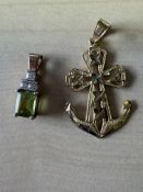 9ct gold pendant set with a green gemstone togethe