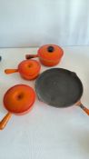 Le Creuset flame-orange cast-iron saucepan and skillet set