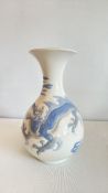 Lladró porcelain bud vase with flared rim, moulded in low relief with a blue dragon amidst