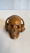 Bronze skull with headphones