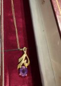 9ct gold pendant with a purple gemstone suspended