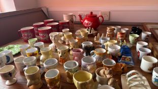 Collection of novelty ceramic egg cups, KitKat mugs and teapot