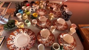 Polychrome tea service with assorted novelty egg cups