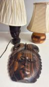 Group of wooden table lamps and carved wall mask