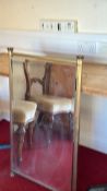 Rectangular clear glass firescreen within brass frame, fluted column uprights and compressed bun