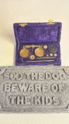 Pocket apothecary balance and humorous cast door plaque