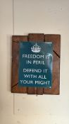 Metal reproduction sign reading “FREEDOM IS IN PERIL DEFEND IT WITH ALL YOUR MIGHT”, mounted on a