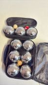 Two sets of chrome patanque boules in carry cases
