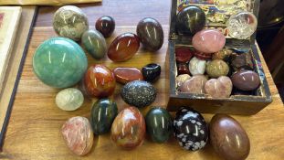 Collection of polished gemstone eggs, spheres and hearts