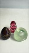 Group of three art glass egg paperweights