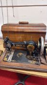 Jones 'Family CS' hand-crank sewing machine with oak case