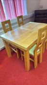 Oak dining table with four upholstered chairs