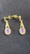 Pair of 18ct gold earrings set with amethyst and w
