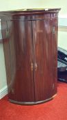 Mahogany bow-front corner cupboard