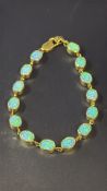 9ct Gold bracelet set with 14 opals Total weight 1
