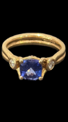 Tanzanite & diamond ring, large central tanzanite with diamonds on each shoulder set in 18ct gold.